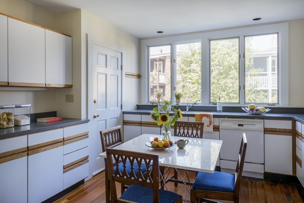 73-75 Upland Road Cambridge, MA 02140 - Photo 7 of 26 a kitchen with a dining table chairs and window