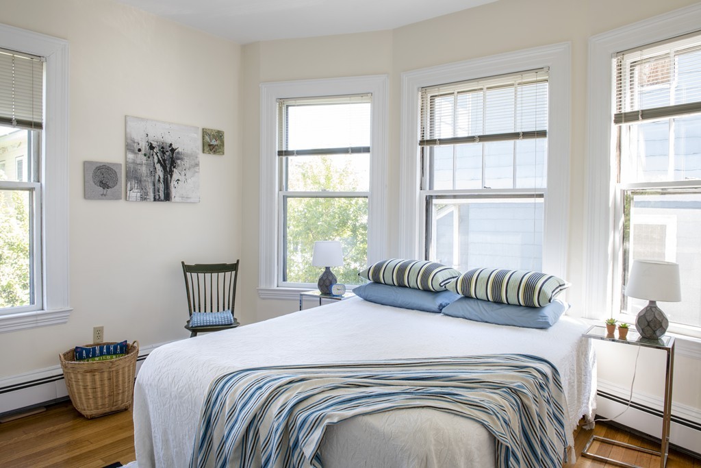 73-75 Upland Road Cambridge, MA 02140 - Photo 9 of 26 a bedroom with a bed and wooden floor