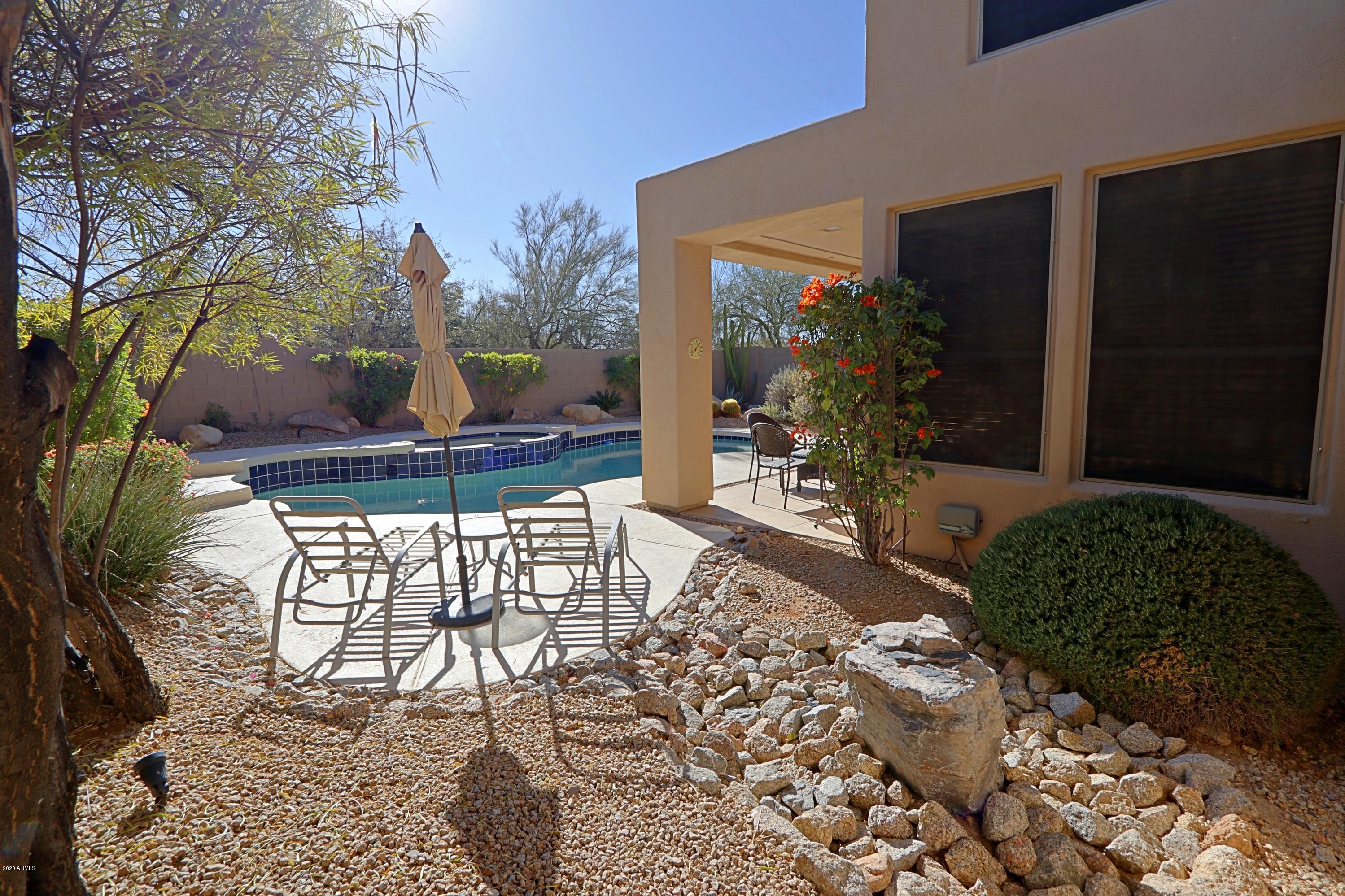 6803 East Eagle Feather Road Scottsdale, AZ 85266 - Photo 27 of 67 a view of a patio with table and chairs and potted plants