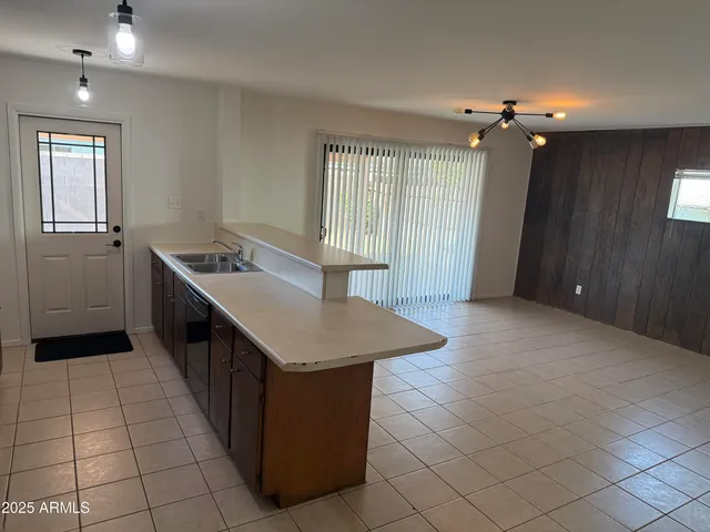 a kitchen with stainless steel appliances a sink stove and cabinets