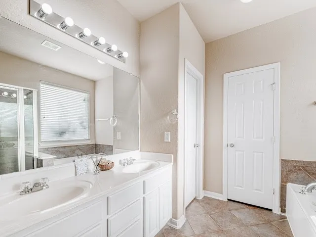 a bathroom with a sink double vanity and a mirror