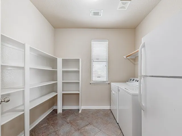 a view of a storage & utility room with a washer dryer