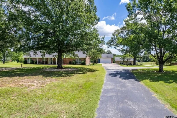 a view of a house with yard and a garden