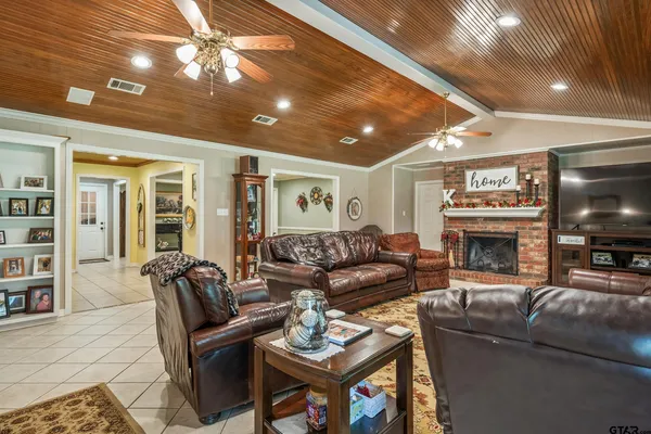 a living room with furniture a fireplace and a flat screen tv