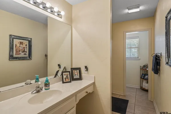 a bathroom with a sink vanity granite and a mirror