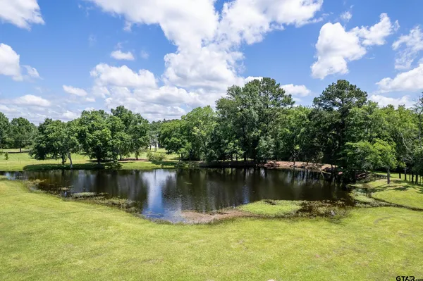 a view of a lake with a house in the background