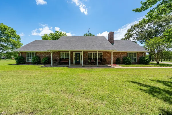 a view of a house with a yard and garage