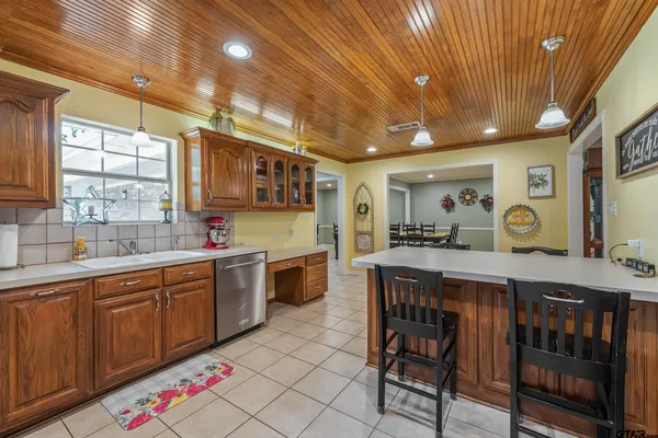 a large kitchen with lots of counter space and breakfast area