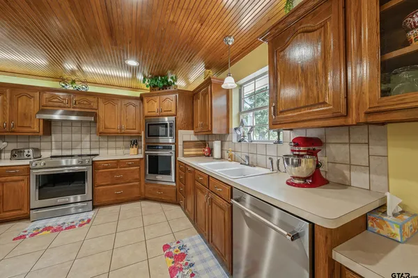 a kitchen with a sink cabinets and appliances