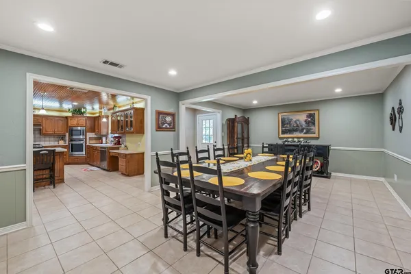 a dining area with furniture and a large window