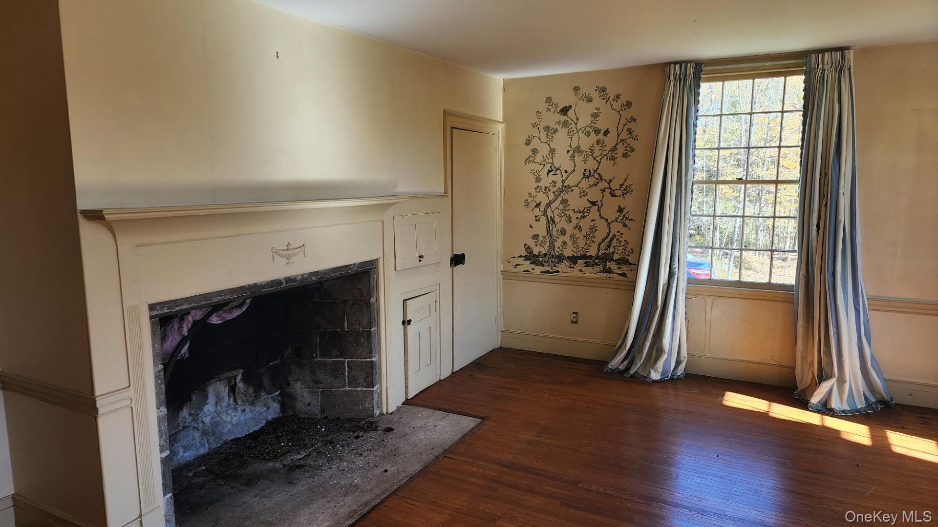 175 Waccabuc Road Goldens Bridge, NY 10526 - Photo 11 of 36 Unfurnished living room with dark wood finished floors and a tile fireplace