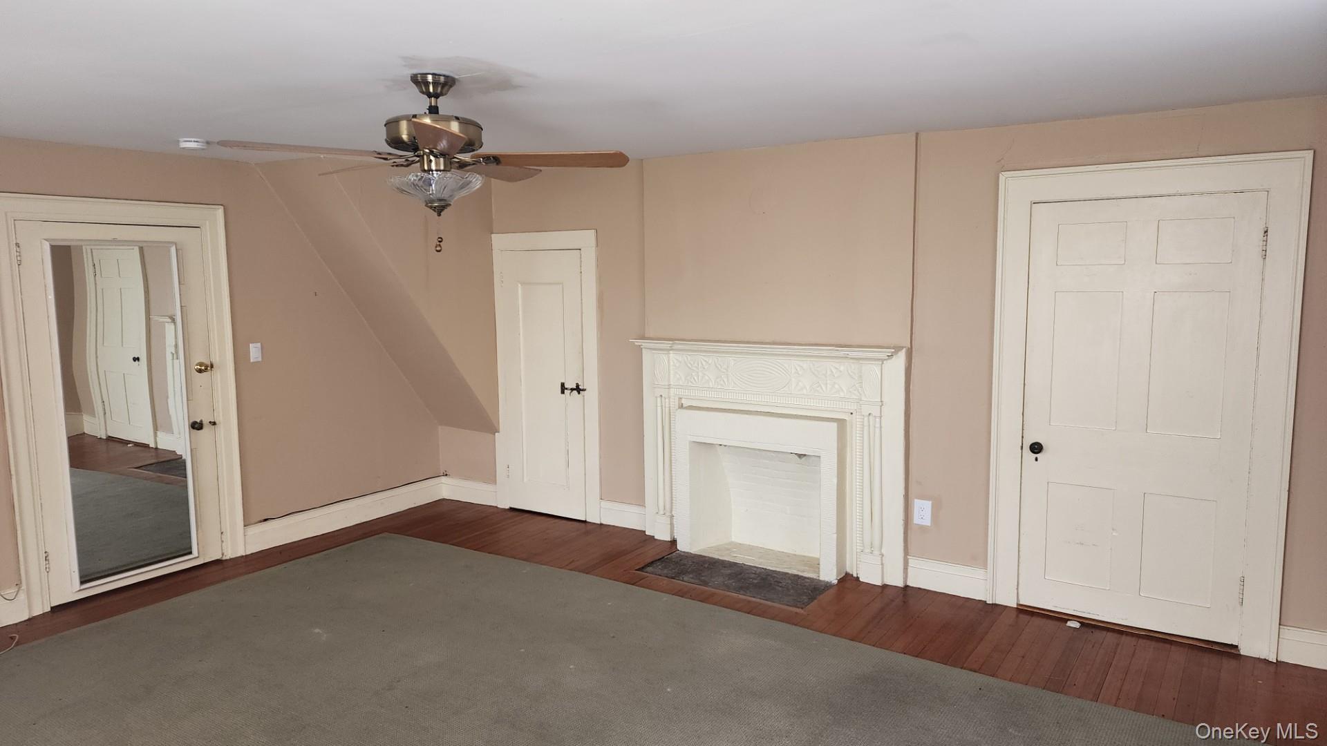 175 Waccabuc Road Goldens Bridge, NY 10526 - Photo 15 of 36 Unfurnished living room featuring dark wood finished floors and ceiling fan