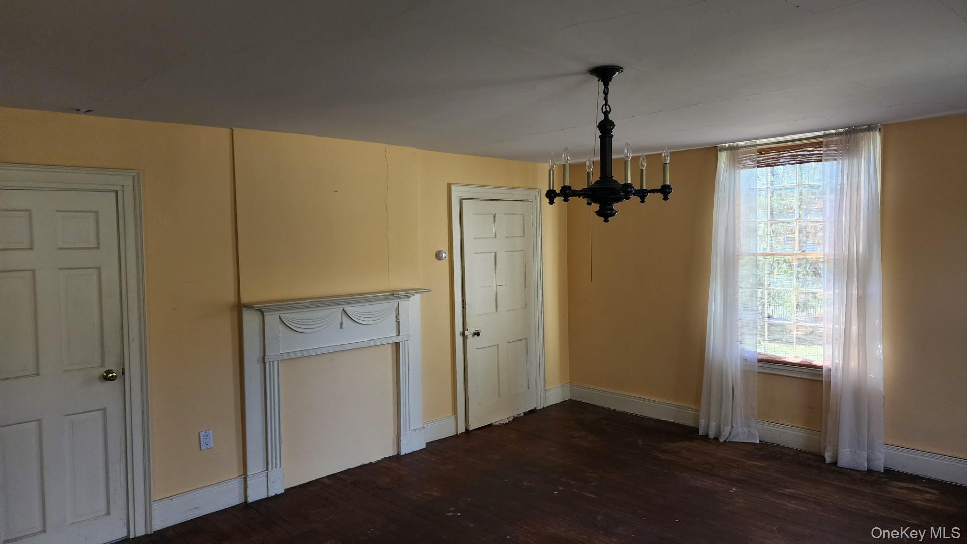 175 Waccabuc Road Goldens Bridge, NY 10526 - Photo 19 of 36 Unfurnished dining area with dark wood-style floors and a chandelier