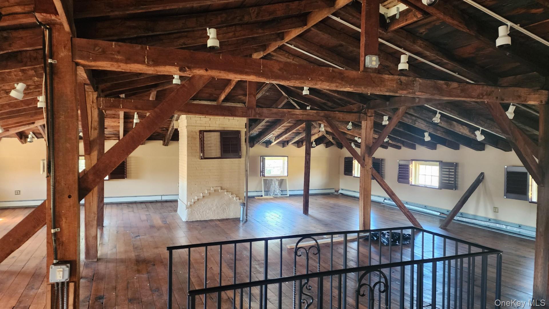 175 Waccabuc Road Goldens Bridge, NY 10526 - Photo 25 of 36 Unfinished attic with plenty of natural light, a baseboard radiator, and a baseboard heating unit