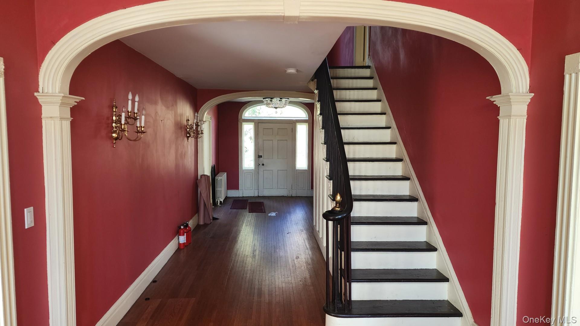 175 Waccabuc Road Goldens Bridge, NY 10526 - Photo 10 of 36 Foyer entrance with arched walkways, stairway, and dark wood-style flooring