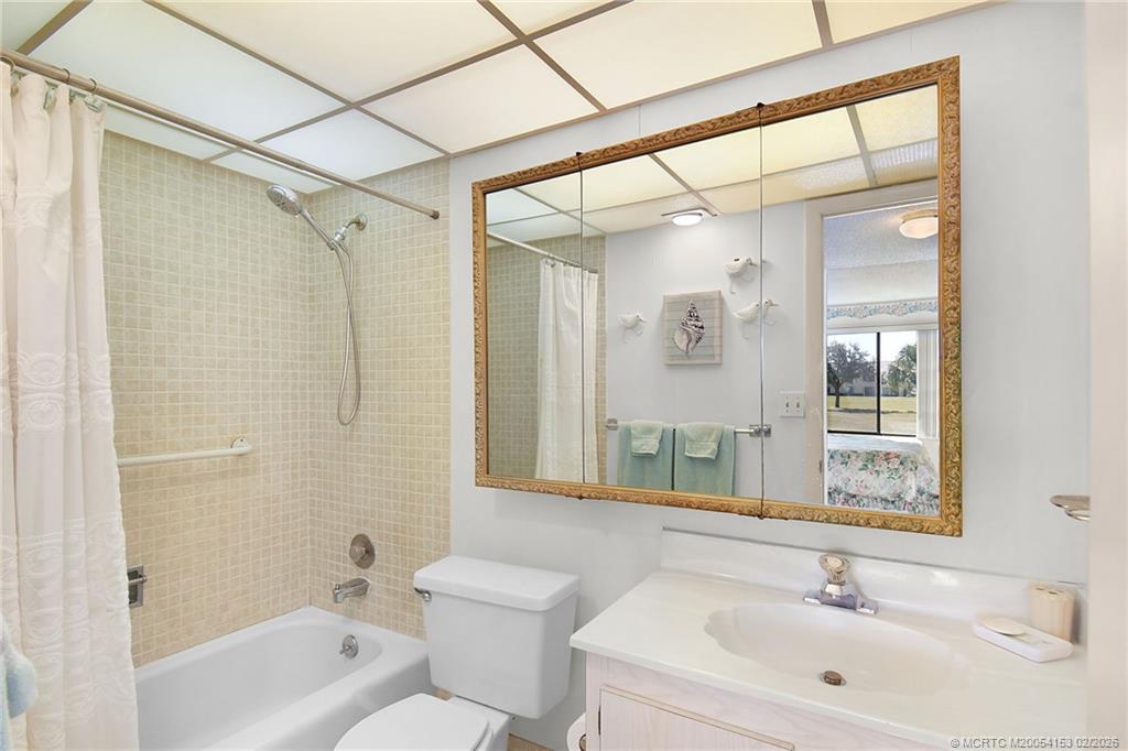 5413 Southeast Miles Grant Road, Unit G206 Stuart, FL 34997 - Photo 14 of 79 a bathroom with a sink mirror toilet and bathtub