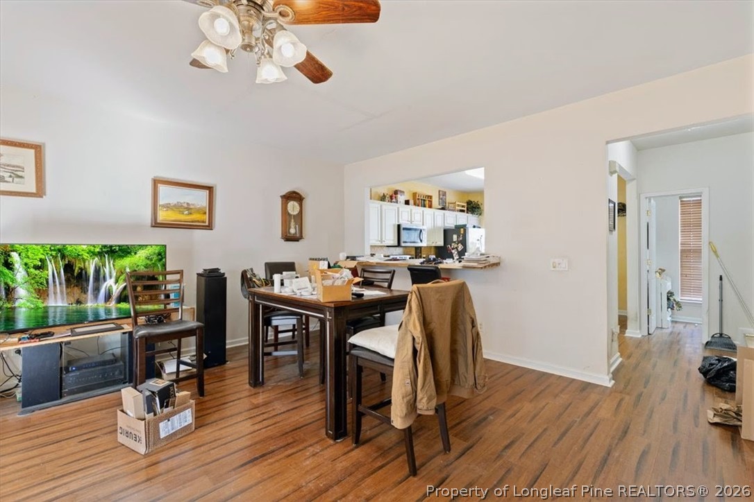 7233 Galon Glen Road Raleigh, NC 27613 - Photo 4 of 6 a view of a workspace with furniture and wooden floor