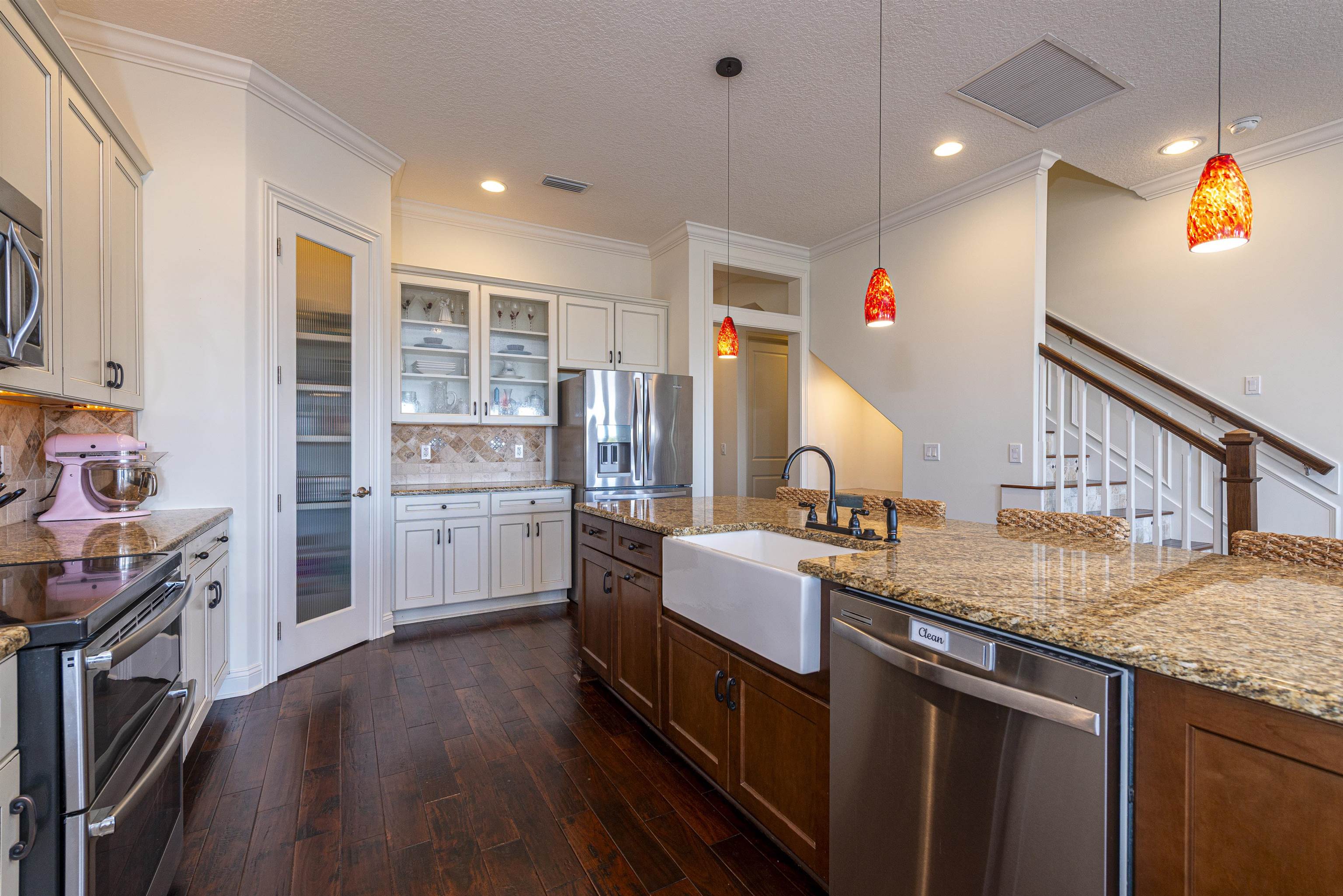 5475 Riverwood Road North St. Augustine, FL 32092 - Photo 11 of 62 Kitchen featuring appliances with stainless steel finishes, glass insert cabinets, pendant lighting, dark wood finished floors, and a textured ceiling