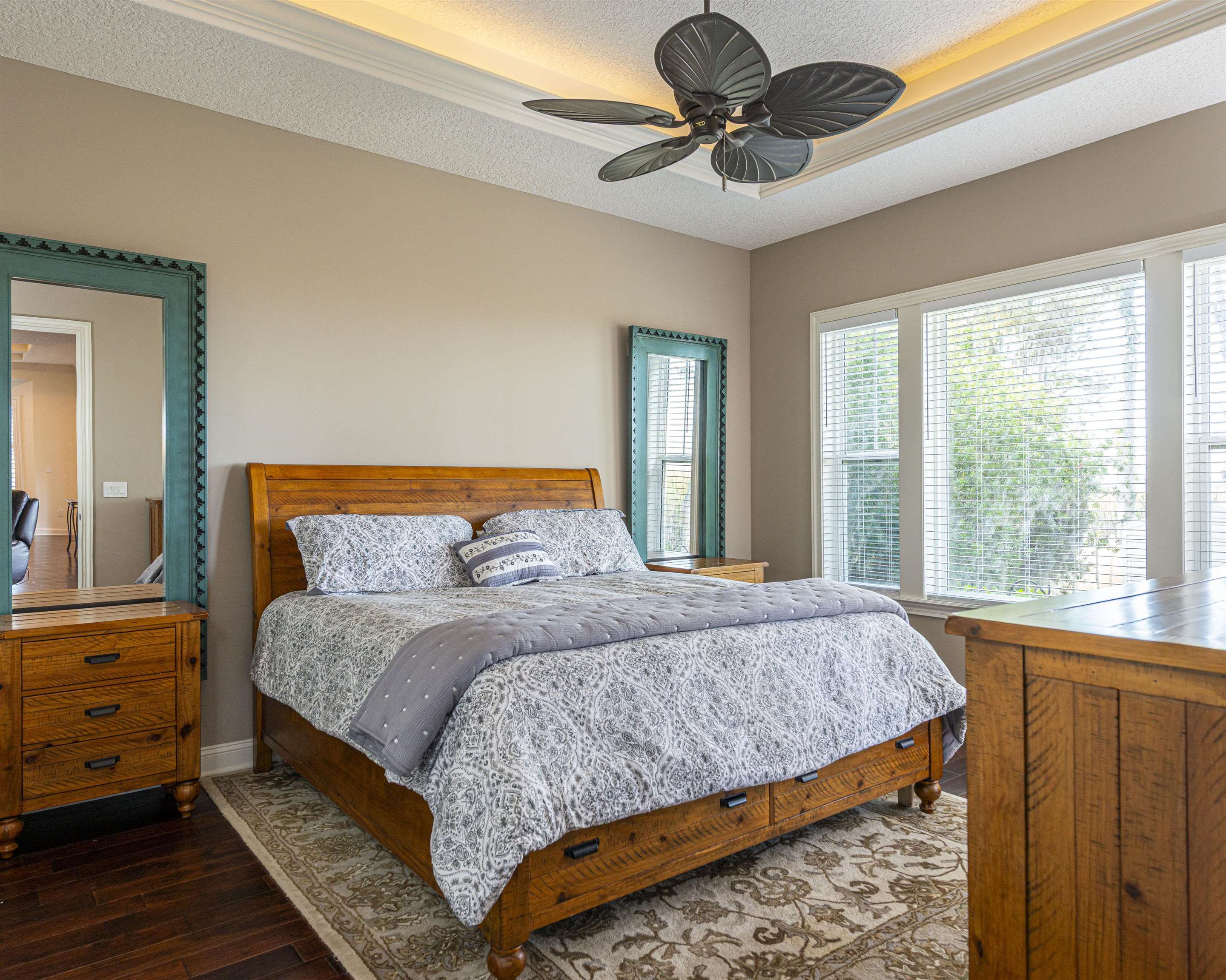 5475 Riverwood Road North St. Augustine, FL 32092 - Photo 13 of 62 Bedroom featuring a textured ceiling, hardwood / wood-style floors, a tray ceiling, and ceiling fan