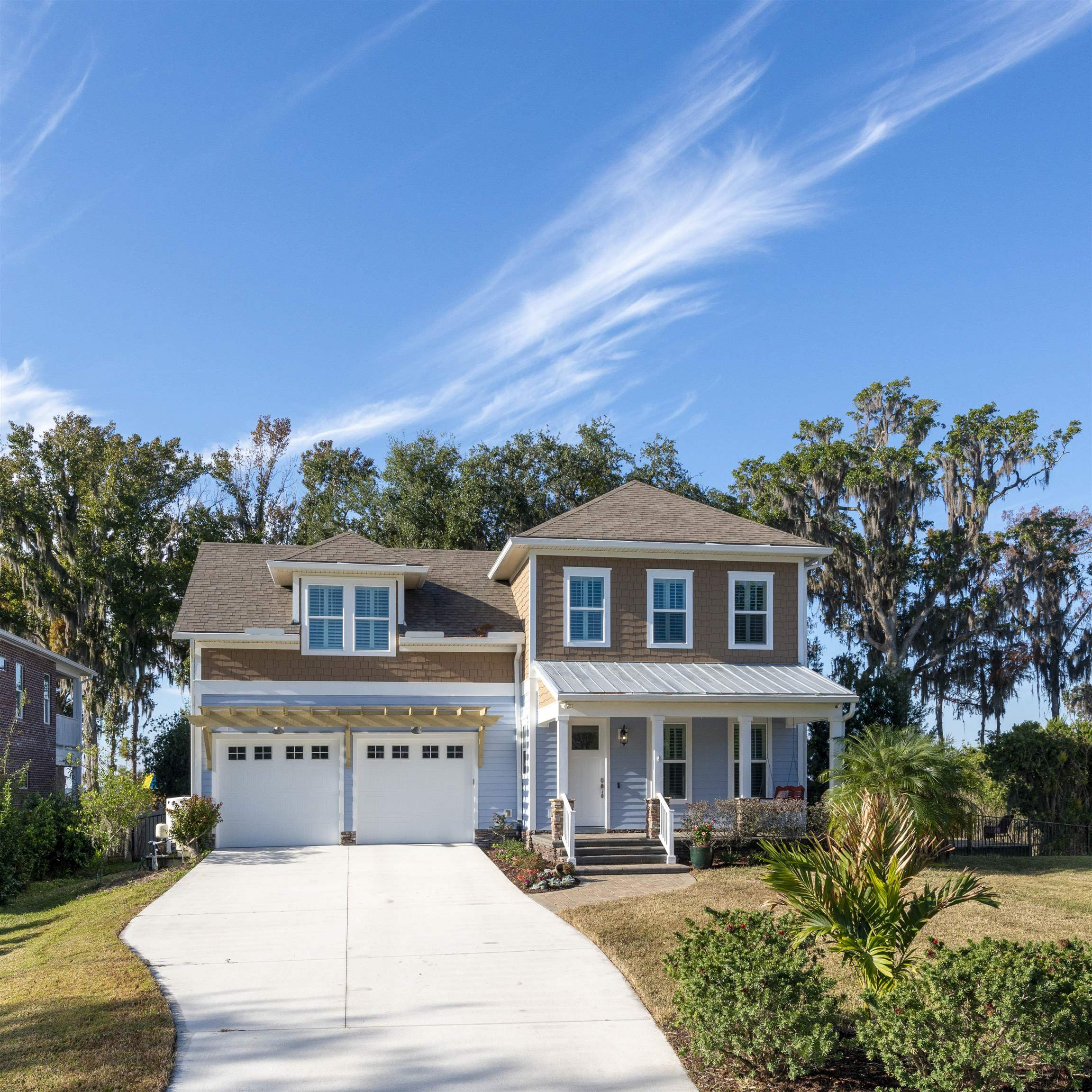 5475 Riverwood Road North St. Augustine, FL 32092 - Photo 2 of 62 View of front facade with covered porch, concrete driveway, and a garage