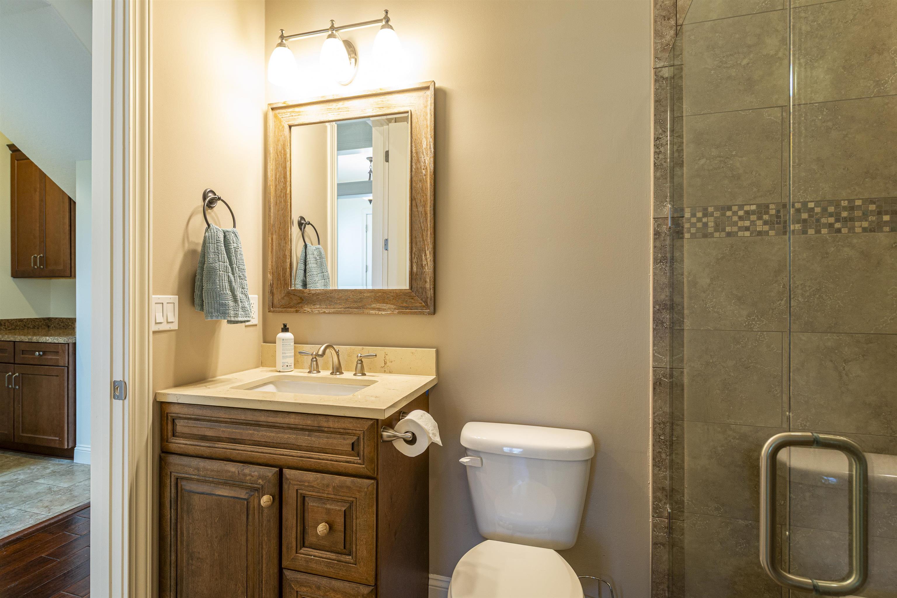 5475 Riverwood Road North St. Augustine, FL 32092 - Photo 22 of 62 Full bathroom with vanity, a stall shower, and dark wood-style flooring