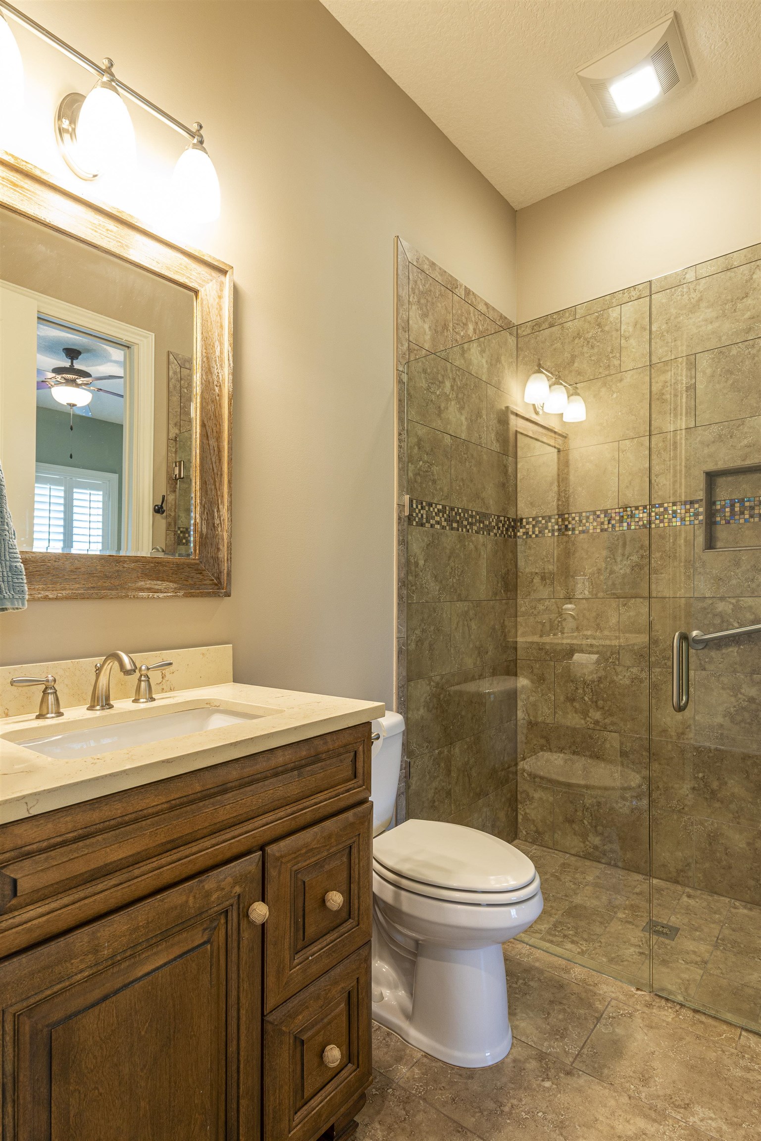 5475 Riverwood Road North St. Augustine, FL 32092 - Photo 23 of 62 Bathroom with vanity, a textured ceiling, a shower stall, and a ceiling fan