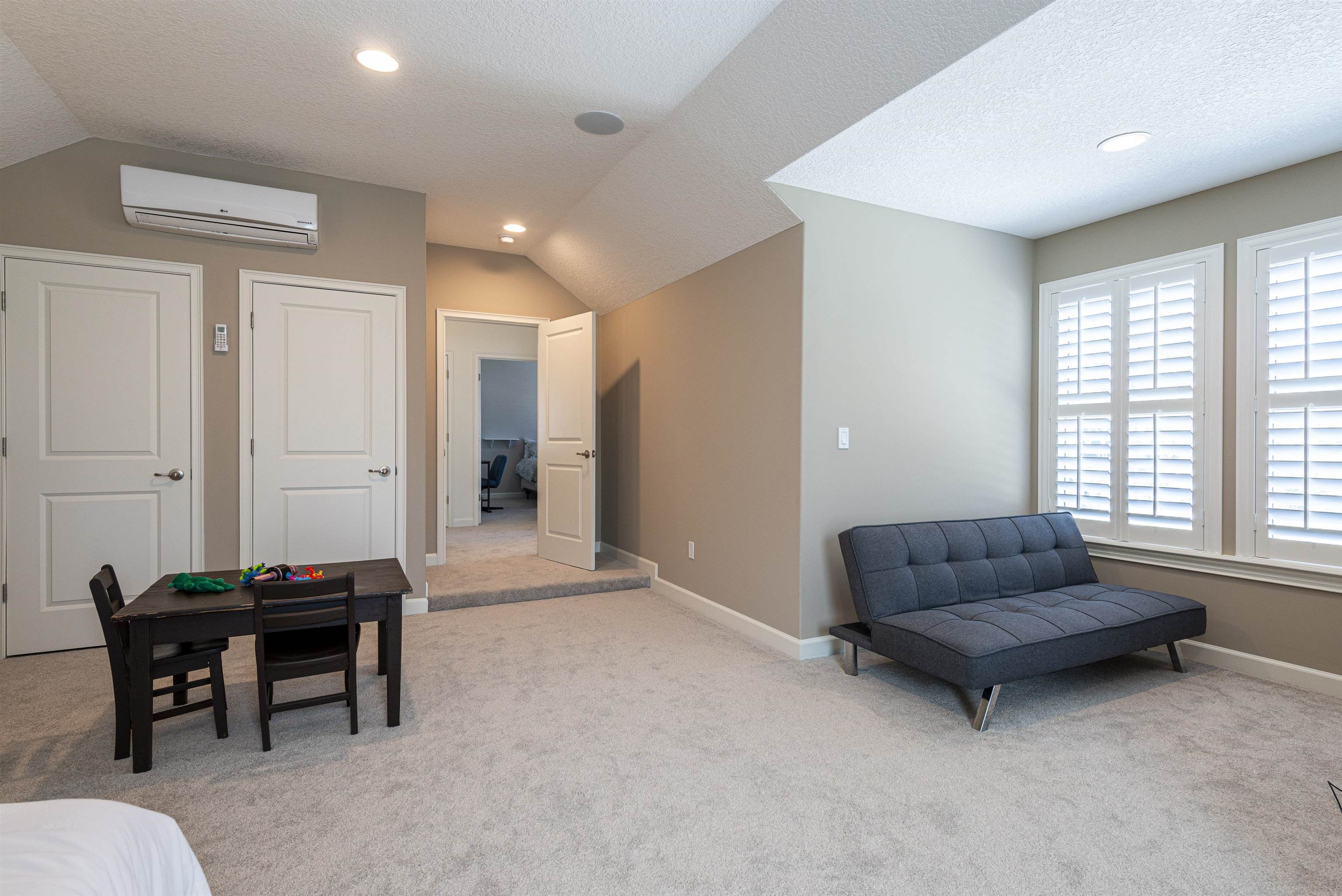 5475 Riverwood Road North St. Augustine, FL 32092 - Photo 39 of 62 Living area with vaulted ceiling, a textured ceiling, an AC wall unit, light colored carpet, and recessed lighting