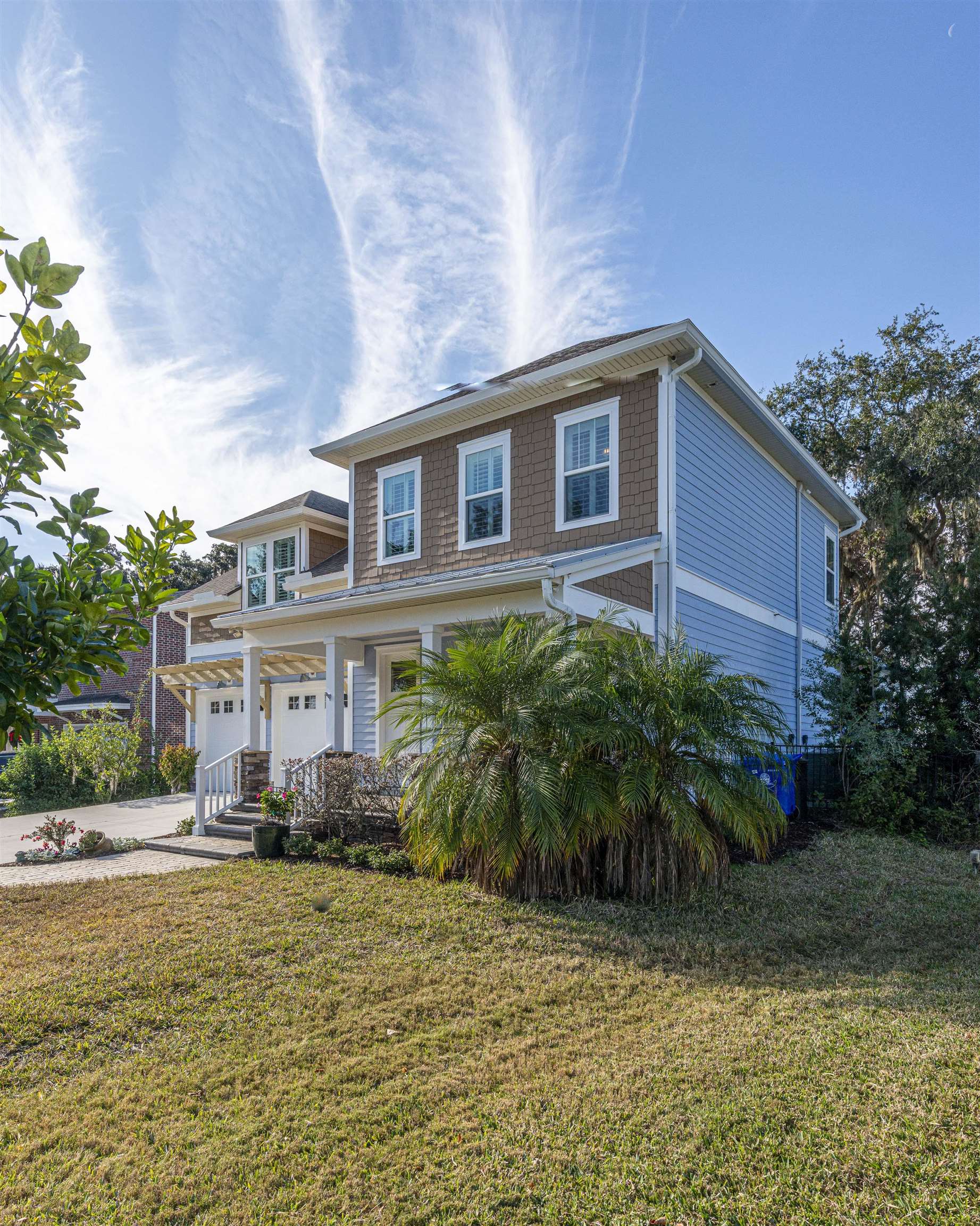 5475 Riverwood Road North St. Augustine, FL 32092 - Photo 49 of 62 View of front of house featuring a porch, a front yard, driveway, and an attached garage