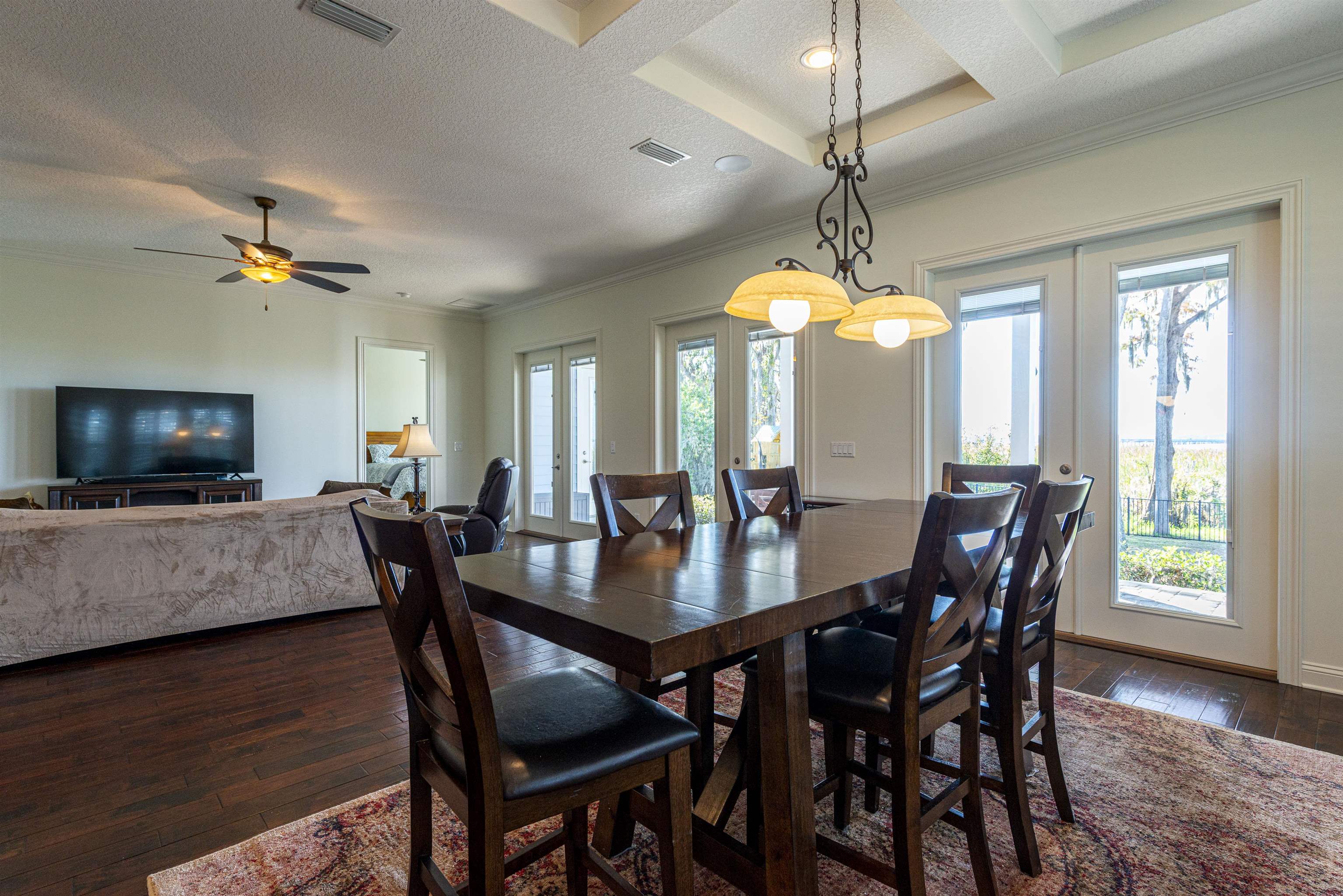 5475 Riverwood Road North St. Augustine, FL 32092 - Photo 6 of 62 Dining area with french doors, dark wood finished floors, a textured ceiling, coffered ceiling, and crown molding