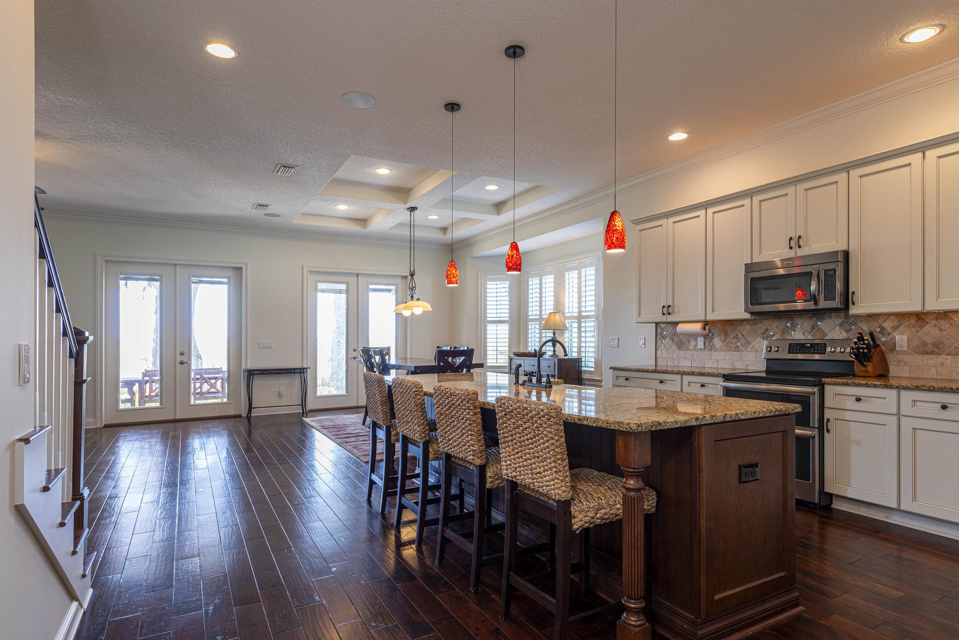 5475 Riverwood Road North St. Augustine, FL 32092 - Photo 10 of 62 Kitchen featuring appliances with stainless steel finishes, a kitchen bar, crown molding, french doors, and dark wood finished floors