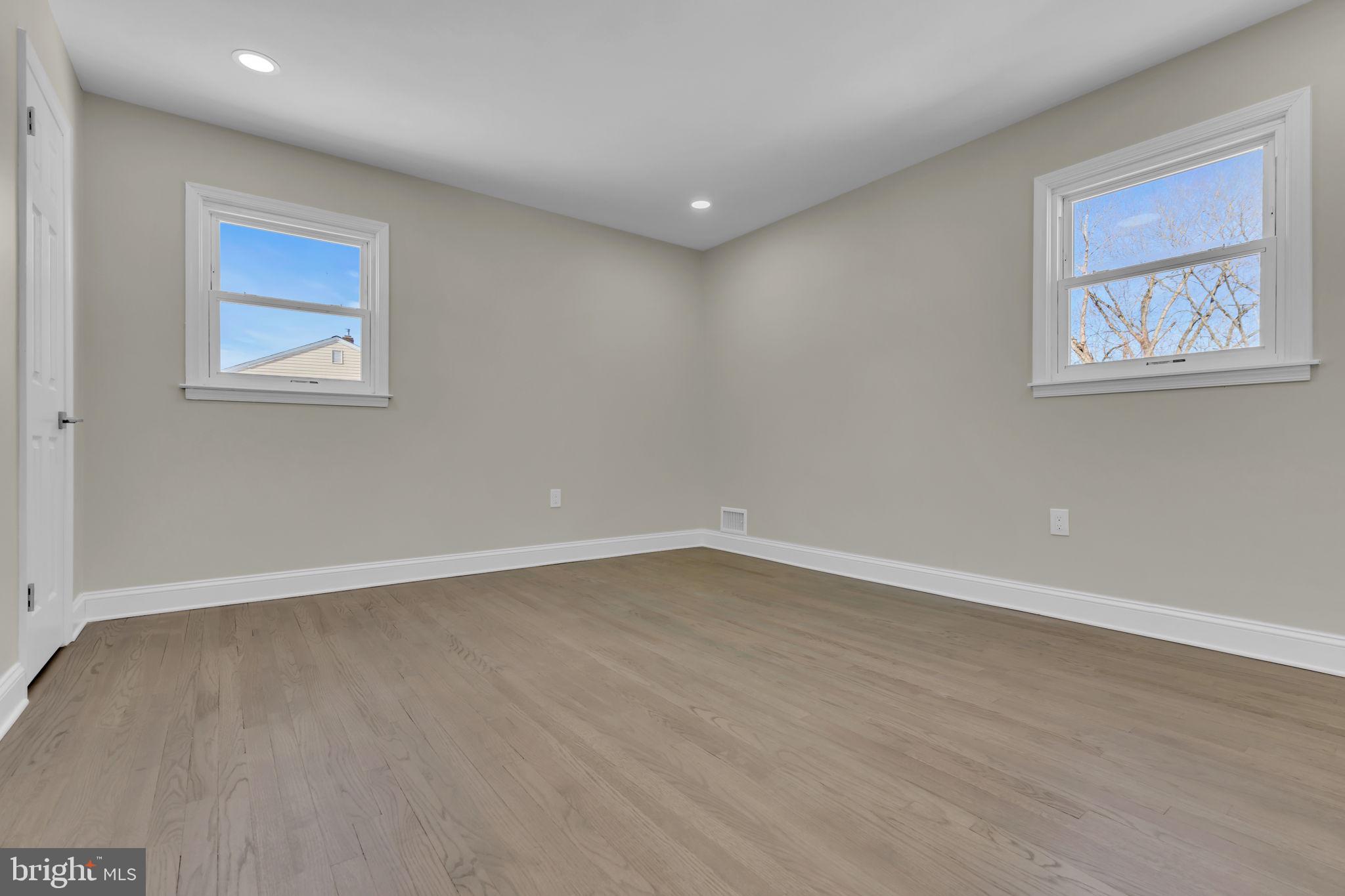 568 Flock Road Trenton, NJ 08690 - Photo 27 of 42 a view of an empty room with wooden floor and a window