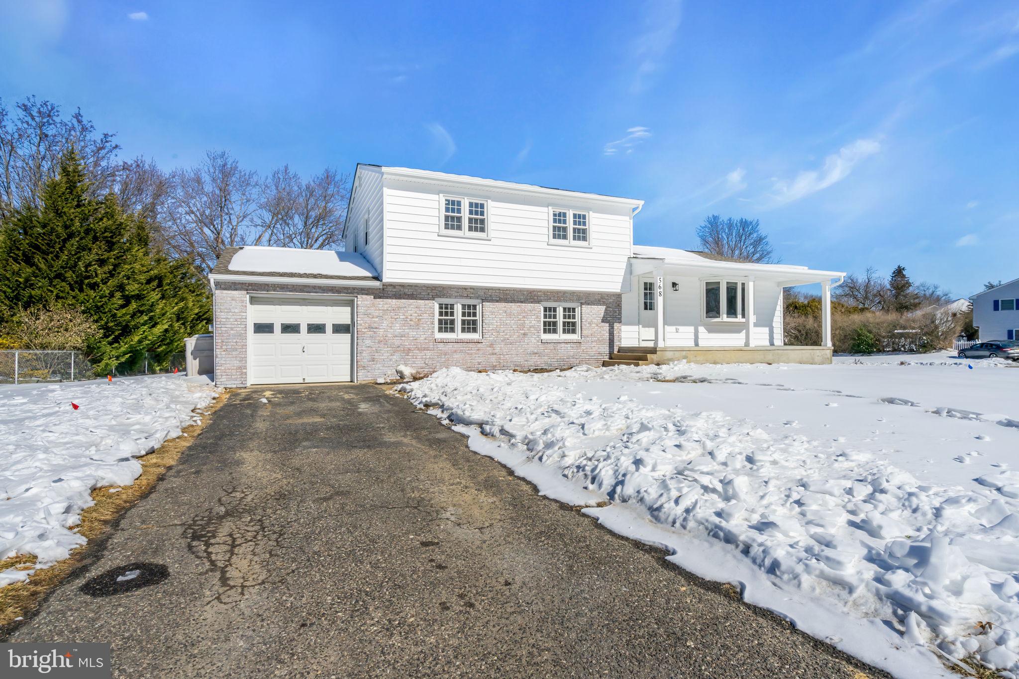 568 Flock Road Trenton, NJ 08690 - Photo 39 of 42 a front view of a house with a yard covered with snow and trees