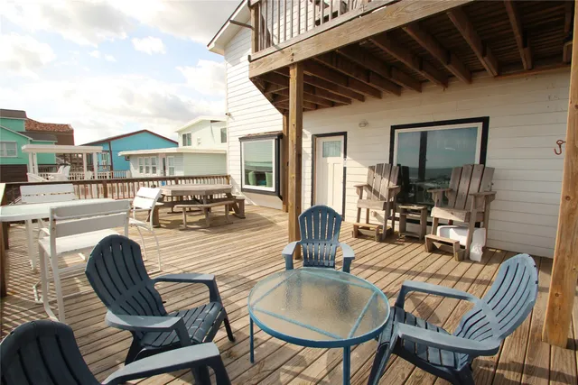 a view of a dining room with furniture a chandelier and wooden floor