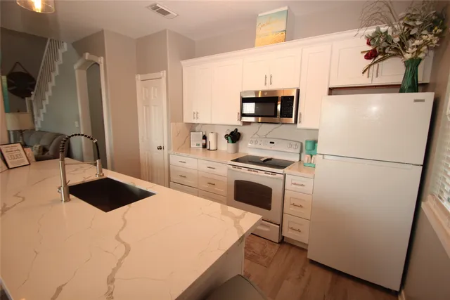a white toilet sitting next to a bathroom sink