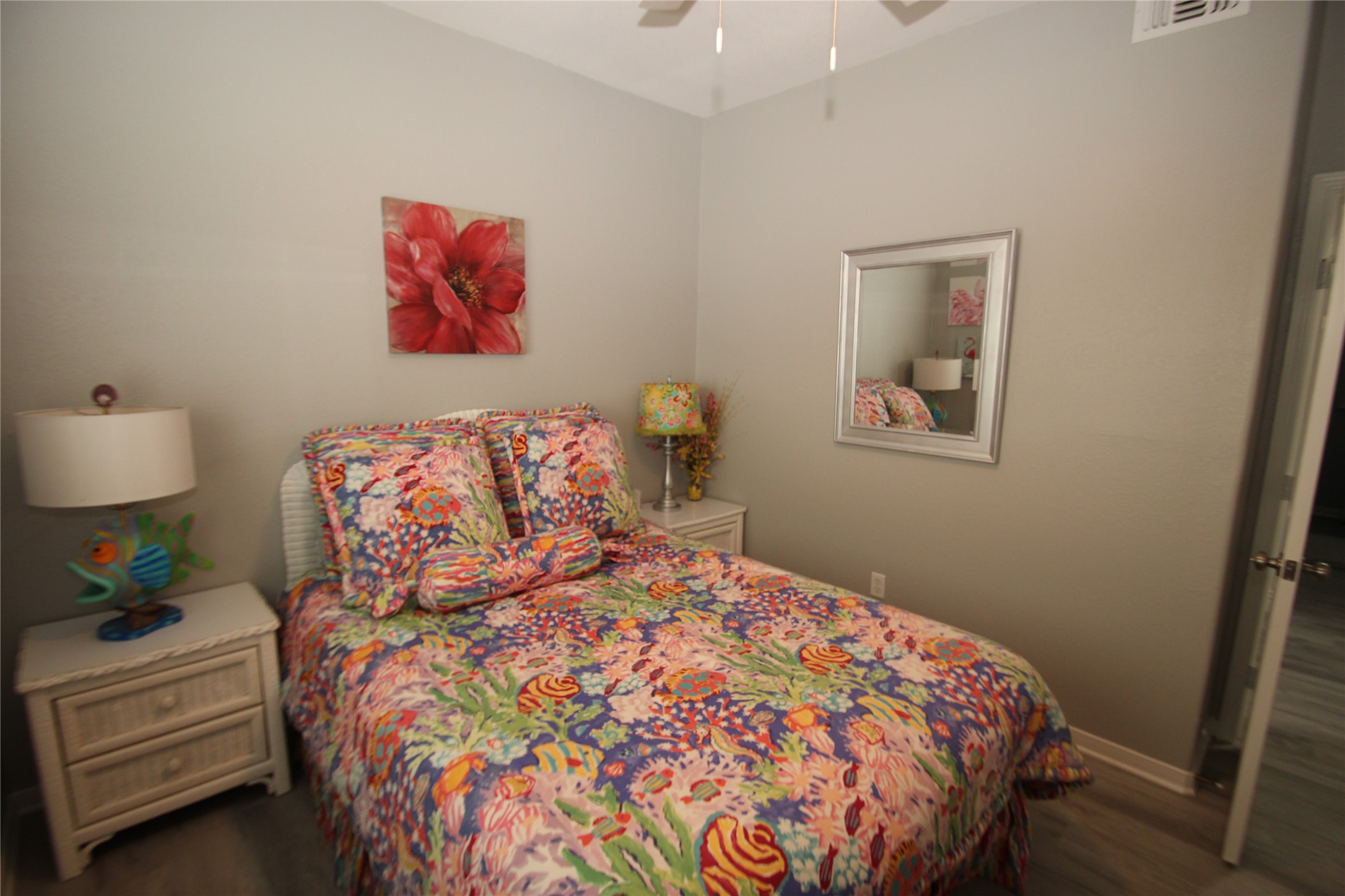 1648 Sandpebble Place Surfside Beach, TX 77541 - Photo 26 of 50 a bedroom with a bed and a lamp on dresser