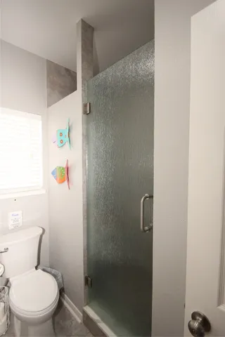 a bedroom with a bed and mirror