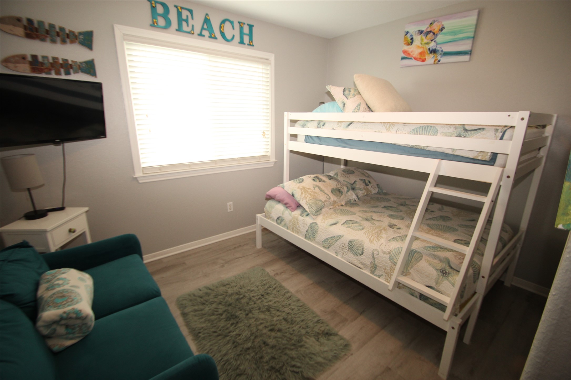 1648 Sandpebble Place Surfside Beach, TX 77541 - Photo 43 of 50 a living room with a couch and a flat screen tv