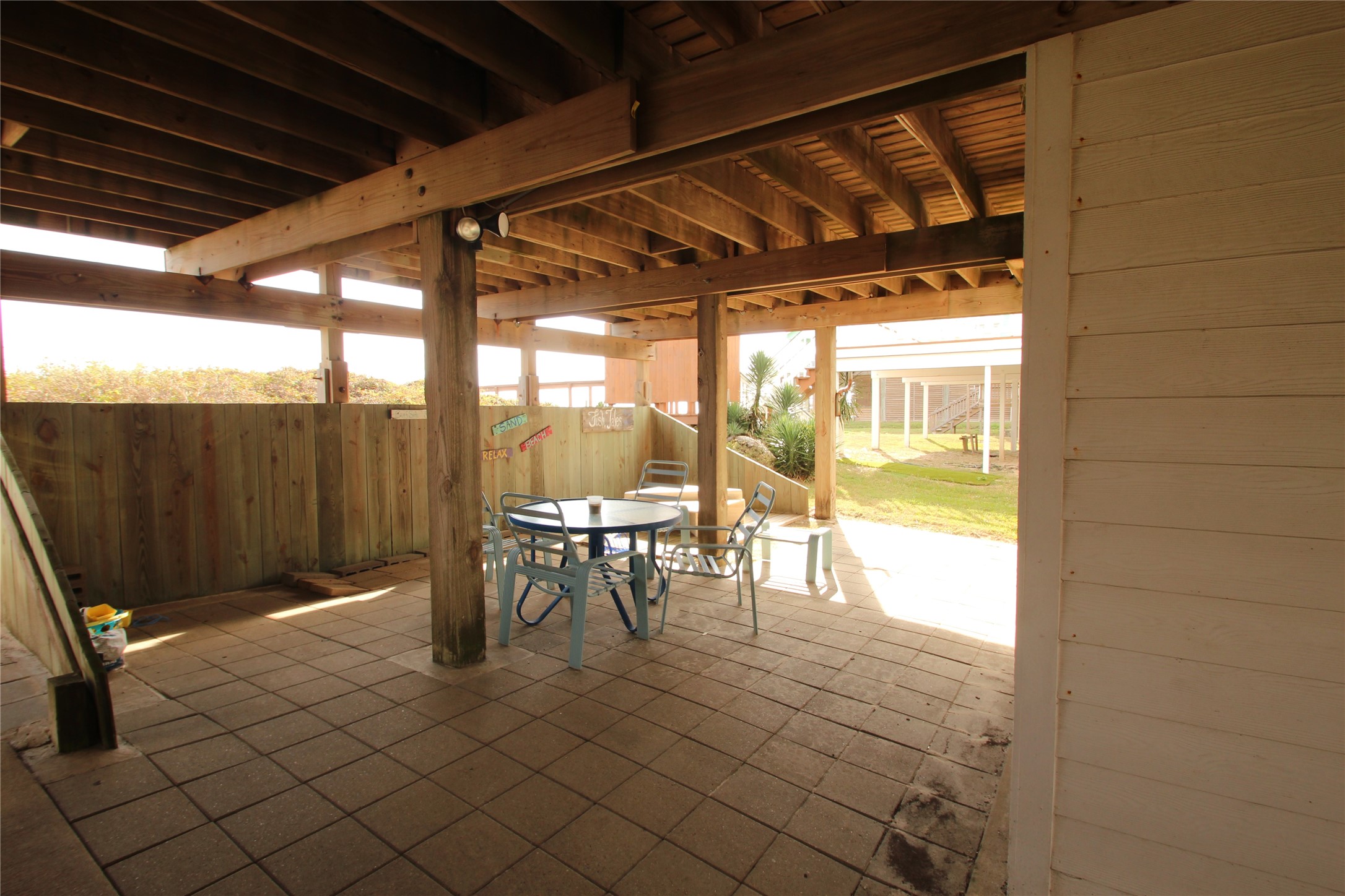 1648 Sandpebble Place Surfside Beach, TX 77541 - Photo 49 of 50 a view of a porch with a table and chairs