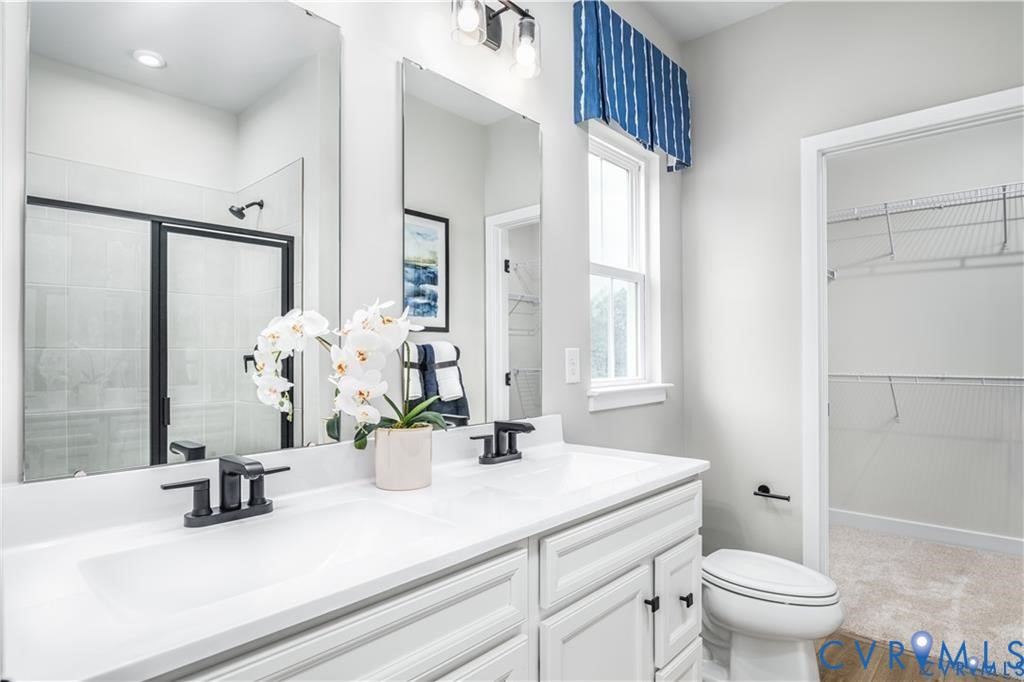 12743 Red Clover Way Midlothian, VA 23112 - Photo 16 of 26 a bathroom with a sink a toilet and a mirror
