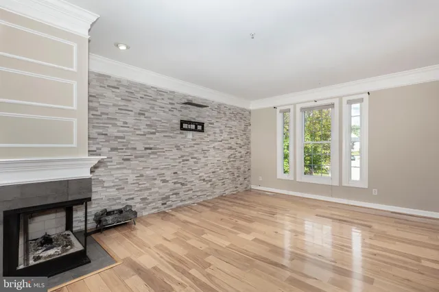 a view of empty room with windows and fireplace