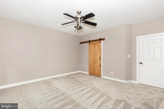 a view of room with window and ceiling fan