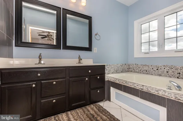 a bath room with a sink and a mirror