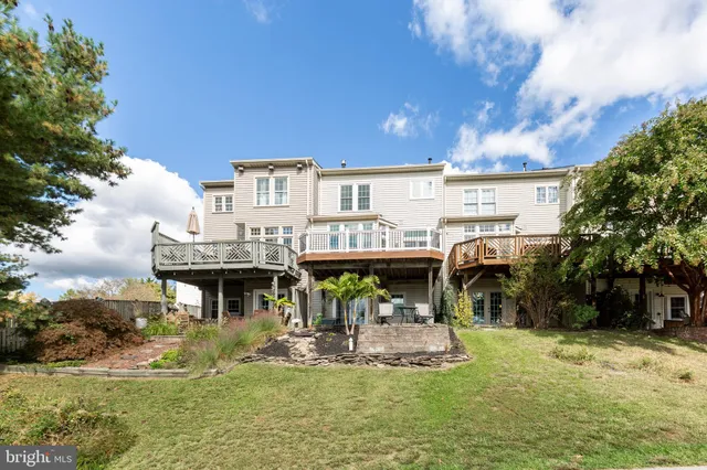 a view of house with a swimming pool and sitting area