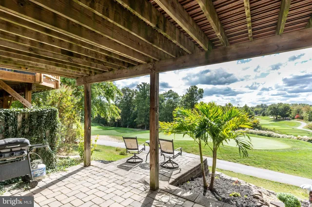 a porch with a table and chairs and potted plants