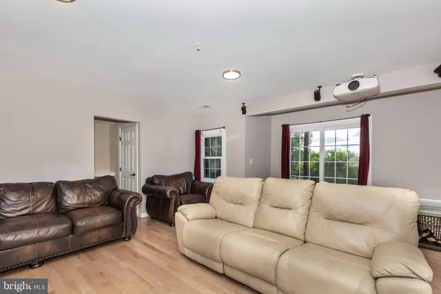a living room with furniture window and couch