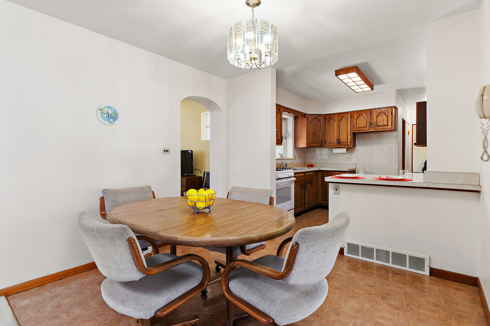 103 South Maple Lane Prospect Heights, IL 60070 - Photo 6 of 17 a kitchen with a dining table and chairs