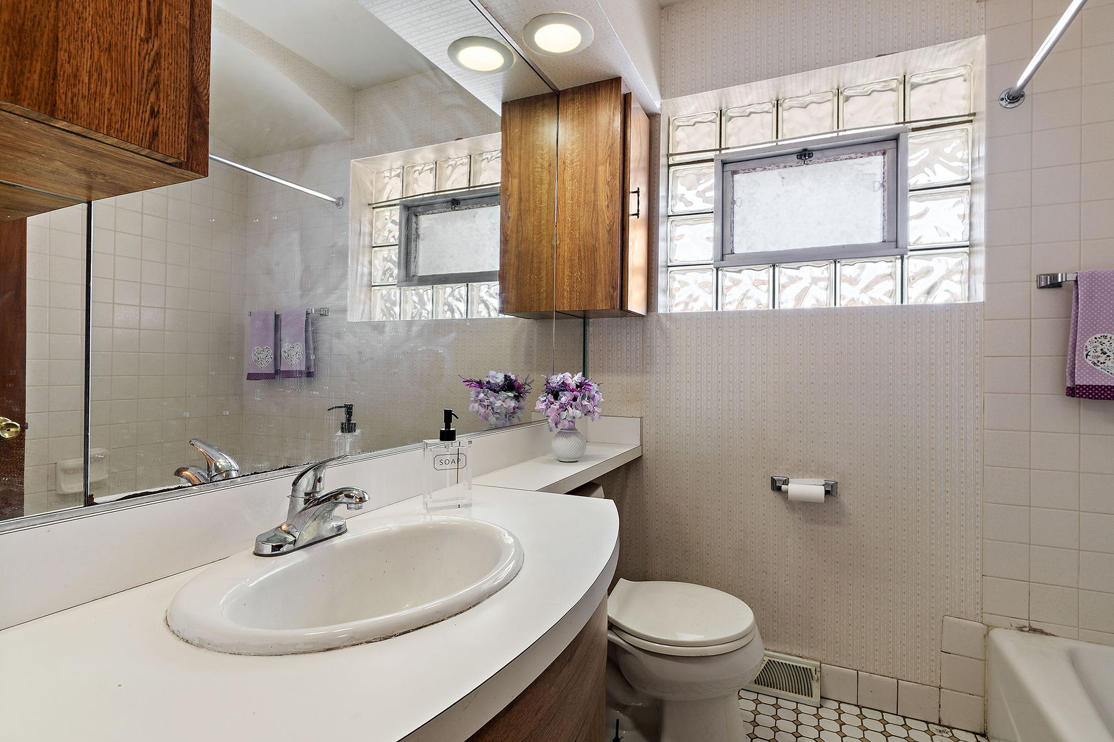 103 South Maple Lane Prospect Heights, IL 60070 - Photo 9 of 17 a bathroom with a sink toilet and a mirror