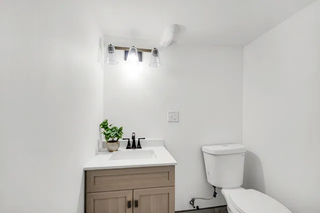 a white toilet sitting next to a bathroom sink