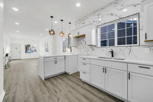 a kitchen with a sink cabinets and window