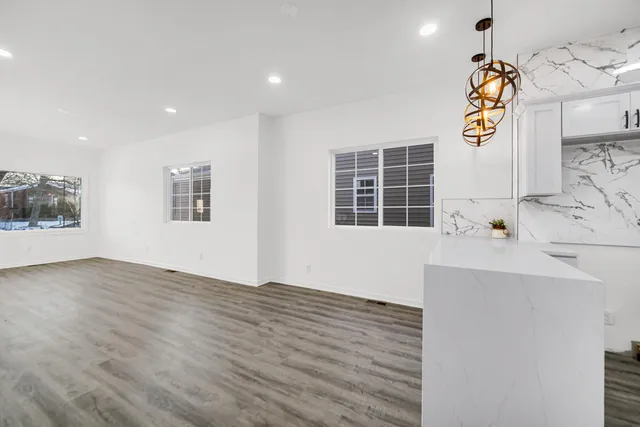 a view of an entryway with wooden floor